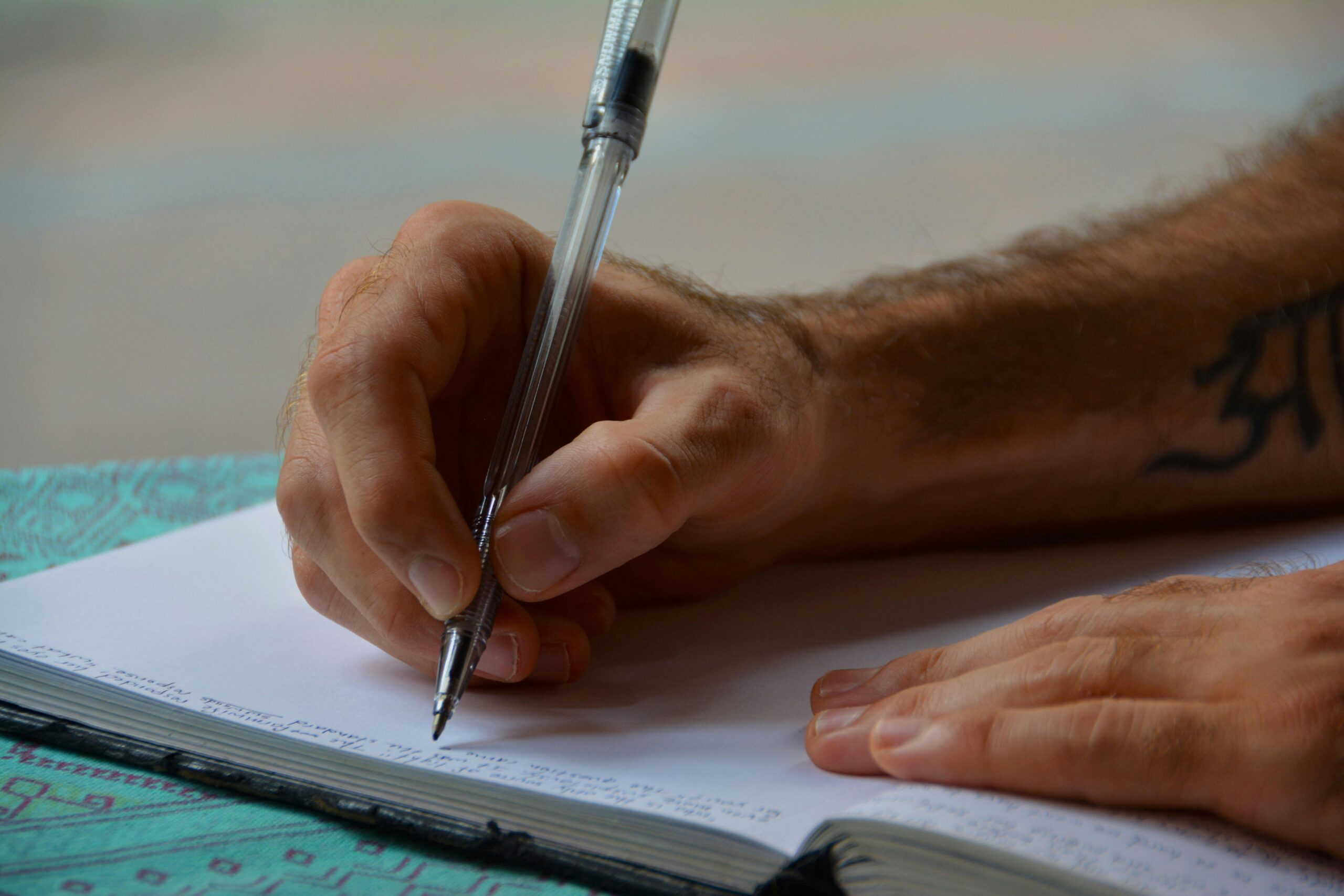 Man writing a letter. | Photo: Pexels